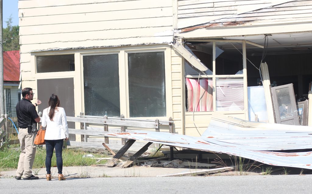 Wayne County Emergency Management Coordinator Craig Brown, left, and UNC-Chapel Hill Professor Mai Nguyen discuss a structure damaged by Hurricane Matthew in downtown Seven Springs, N.C. Photo by Mary Lide Parker.