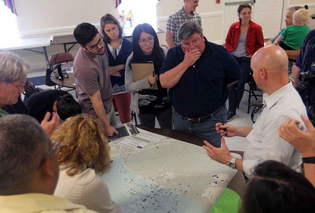 N.C. State University Professor Andrew Fox, right, discusses redesign options for buildings in Seven Springs, N.C., with Mayor Stephen Potter, second from right. Photo by Mary Lide Parker.