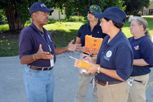 A FEMA Community Relations team, Community Emergency Response Team (CERT) and State Emergency Response Team (SERT) members meet as they go door to door providing outreach for potential Tropical Storm Fay-affected residents in 2008. Photo by George Armstrong/FEMA.