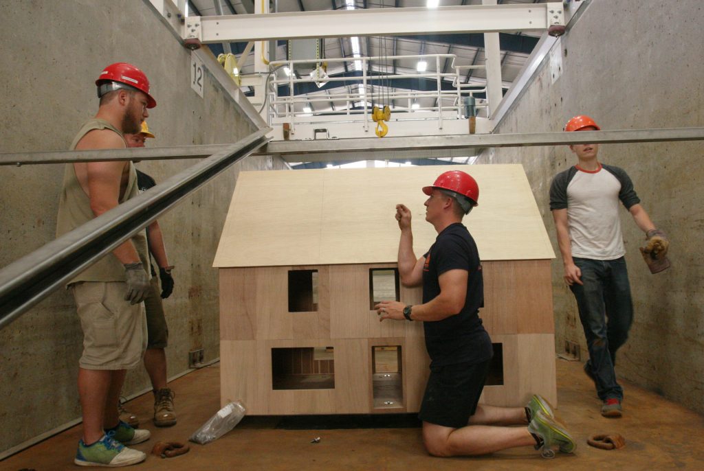 CRC researchers from Oregon State University, along with OSU students and University of Puerto Rico-Mayagüez students taking part in the SUMREX exchange program, test the strength of a model structure in the OH Hinsdale Wave Research Laboratory in the summer of 2018.