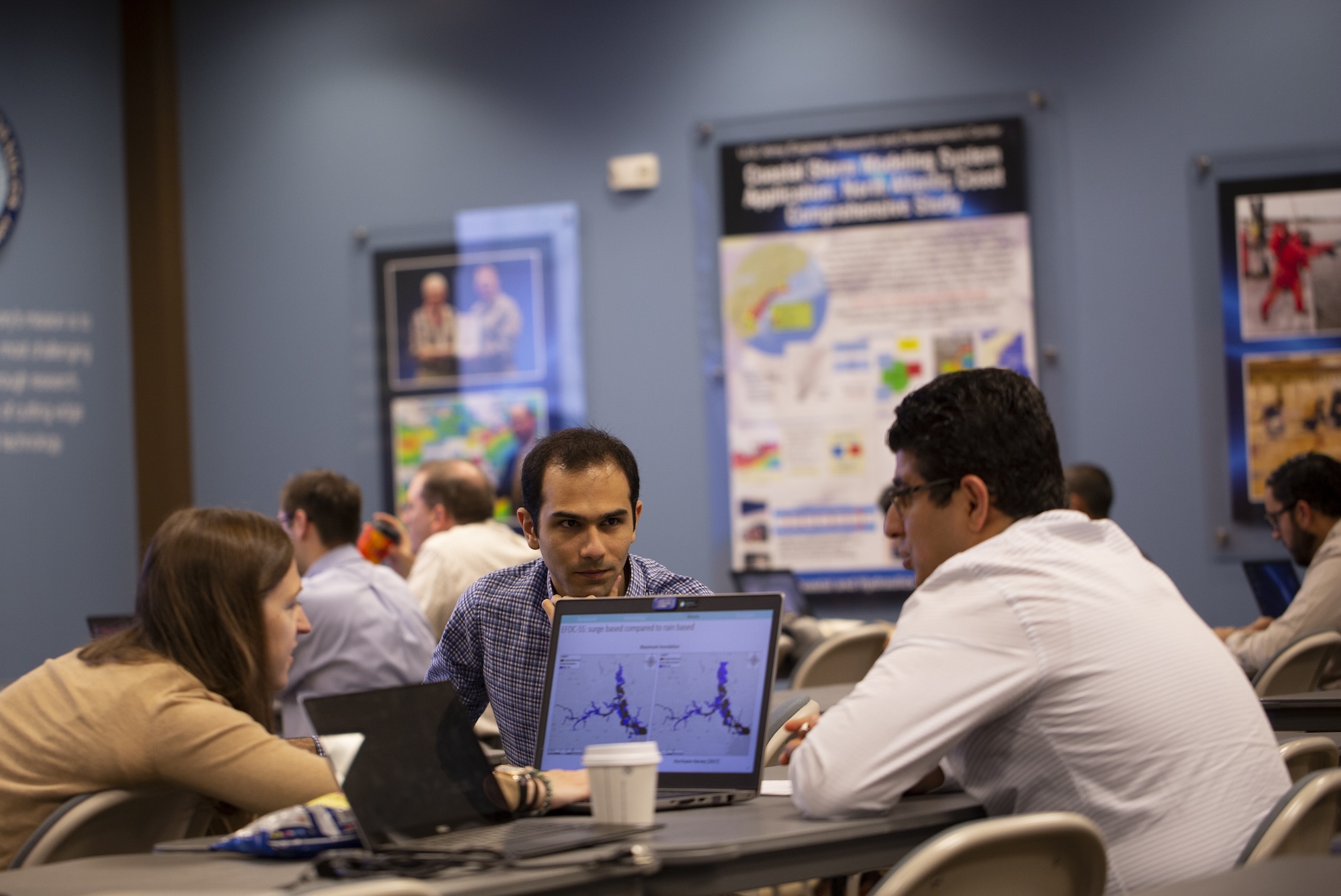 Attendees of the 2019 ADCIRC Users Group Meeting discuss computer models in between presentations. Photo by Chris A. Johns.