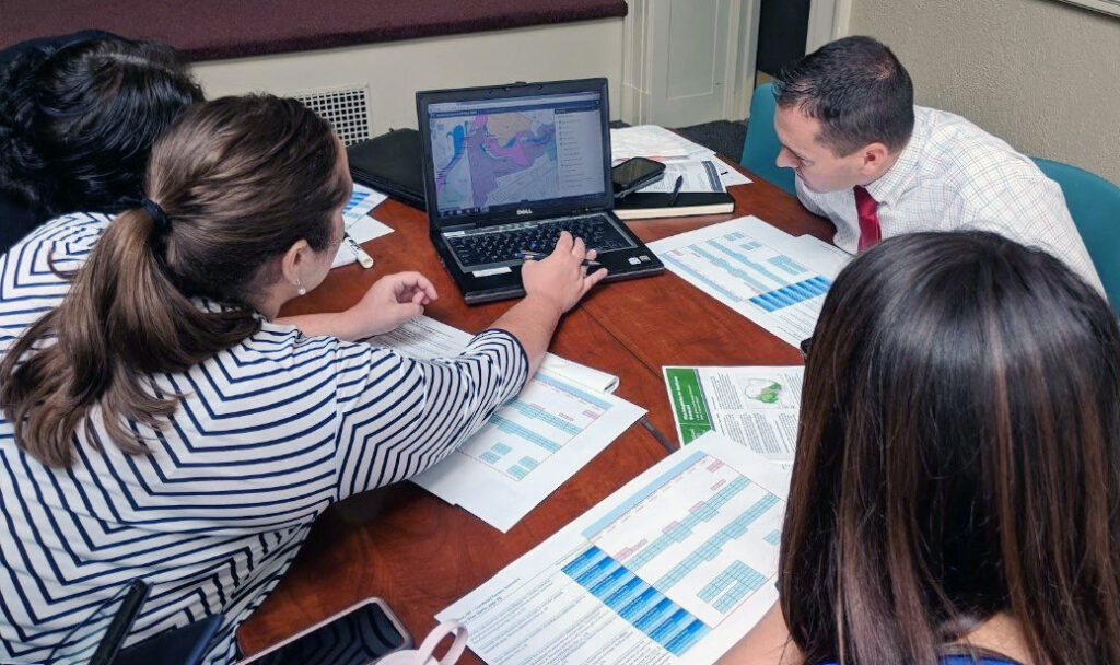 Nashua, N.H., staff and community members deliberating during a Plan Integration for Resilience Scorecard (PIRS) workshop session, held as part of a Resilient Nashua Initiative Stakeholder Meeting at City Hall Auditorium. Photo submitted.