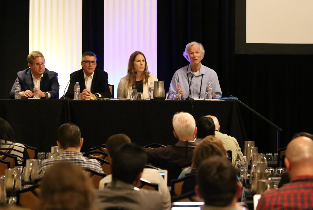 From right, Dr. Phil Berke, Jaimie Masterson, Stephen Cauffman and Joel Max discuss “A Guidebook + A Scorecard = An Integrative Framework for Community Resilience” at the Natural Hazards Workshop in Boulder, Colo., in July. Photo by Dr. Walter Peacock.